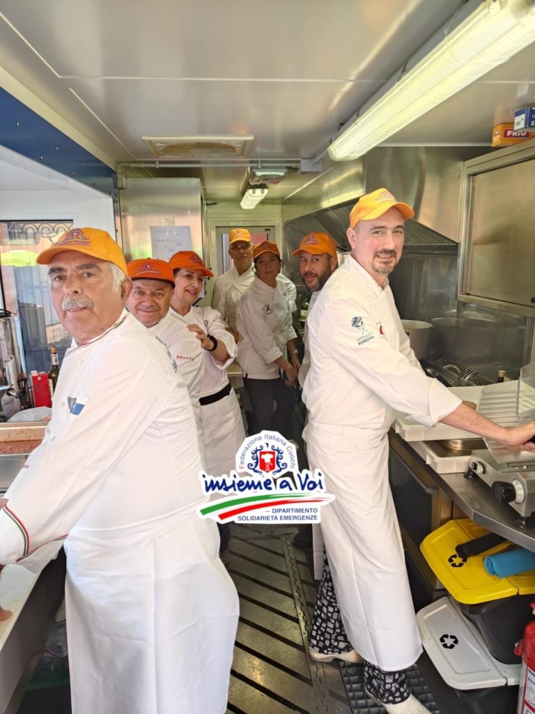 In Emilia-Romagna, dozens of chefs from the FIC Solidarity and Emergency Department (DSEFIC) have worked around the clock to provide hot meals to those whose lives have been upended by the deadly floods. Image: FIC volunteer chefs prepare hot meals in emergency kitchens in Imola and Riolo Terme.
