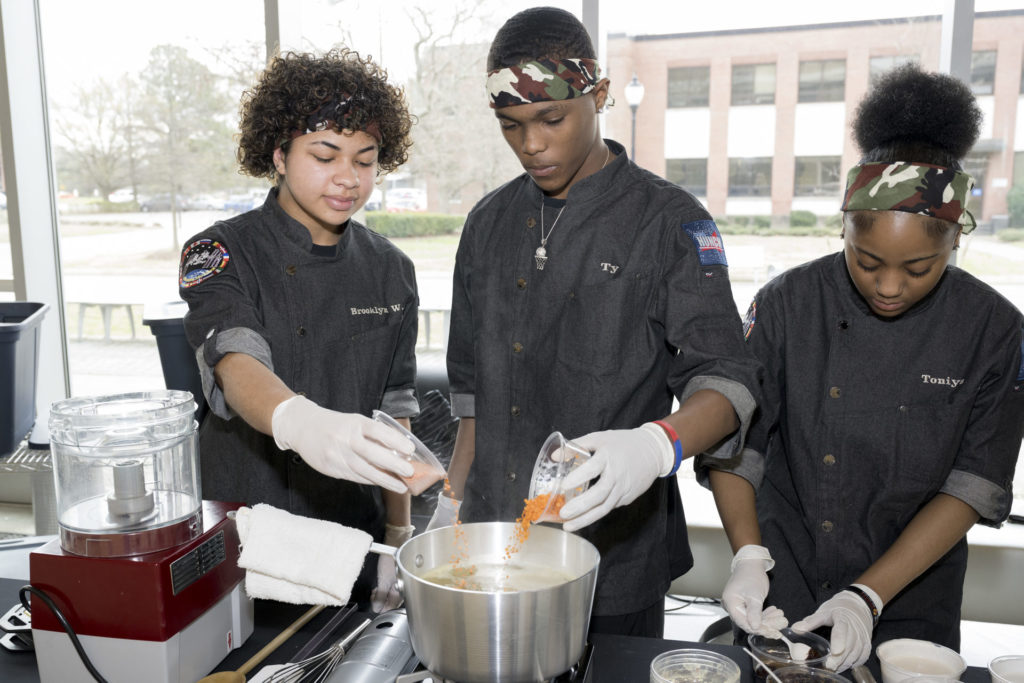 The Phoebus High School culinary team working together to prepare their dish for the judges at the HUNCH Culinary Challenge at NASA's Langley Research Center.
Credits: NASA / Mark Knopp
